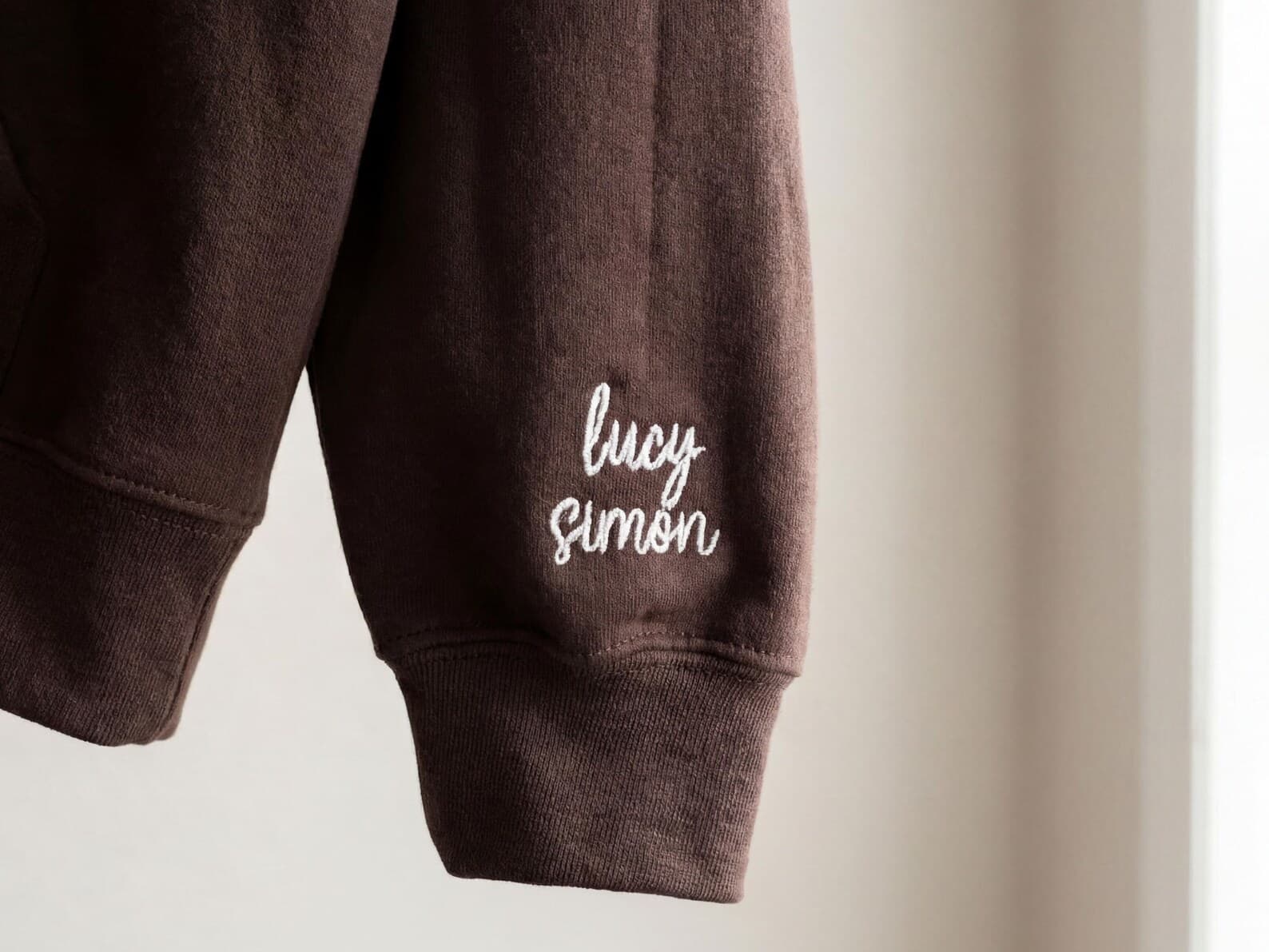 The shop's real photo of a sleeve-embroidered crewneck