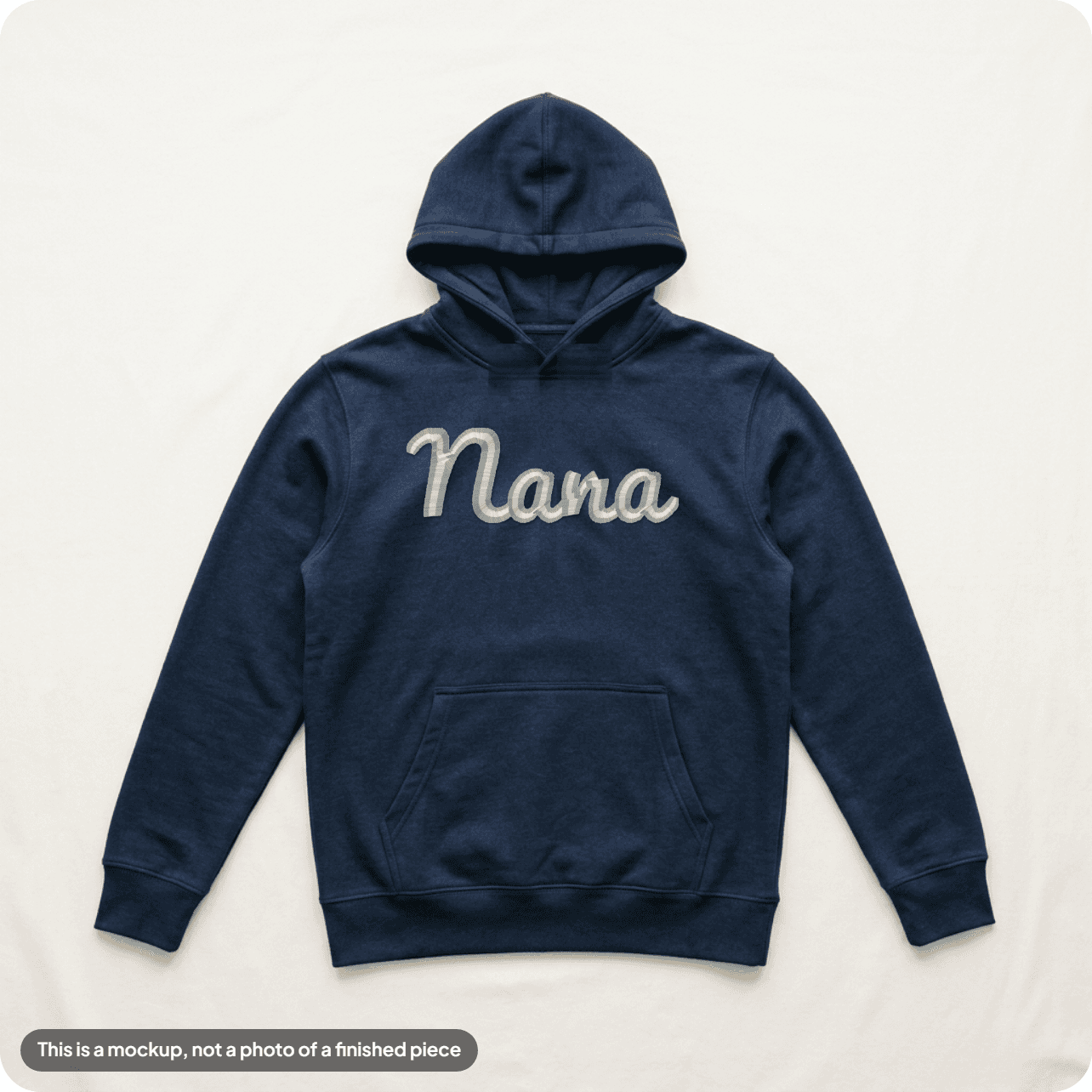 An approved mockup: a name in light thread on a navy hoodie