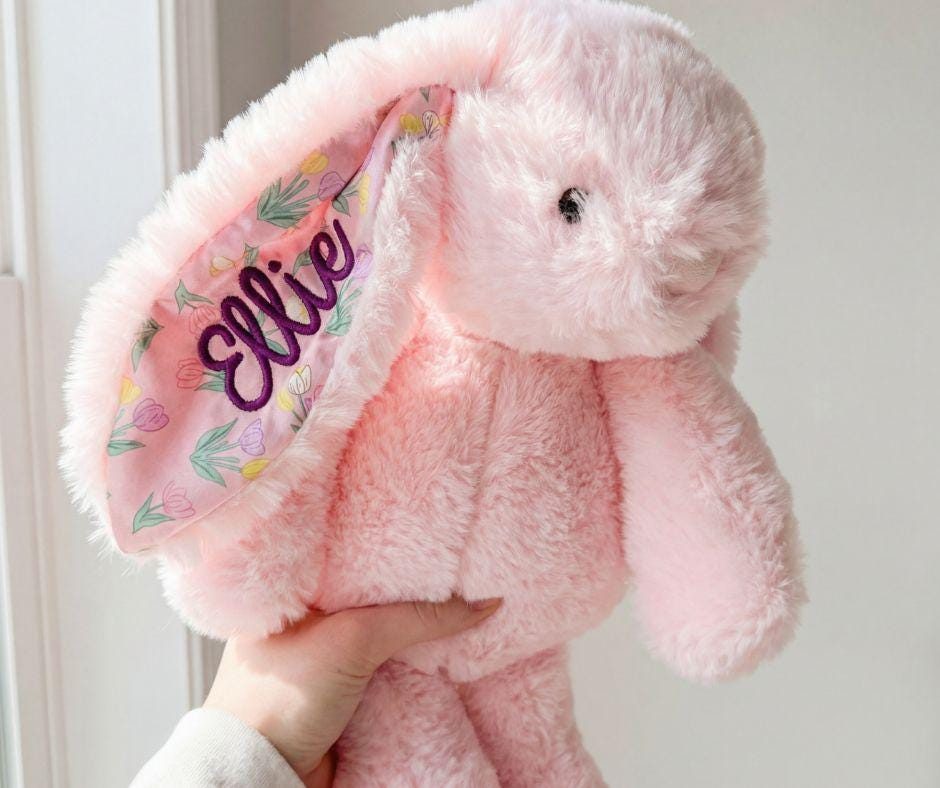 A listing photo of the same bunny held the same way in soft, bright light